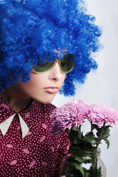 Young beauty clown with flowers — Stock Photo, Image