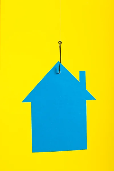 Cardboard house on hook — Stock Photo, Image