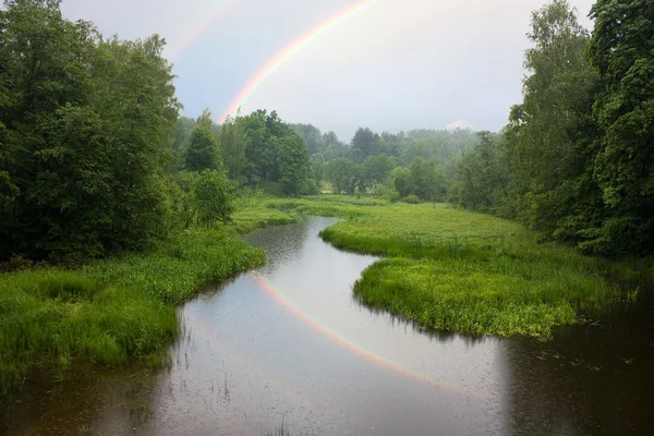 Rainy landscape, a rainbow — Stock Photo, Image