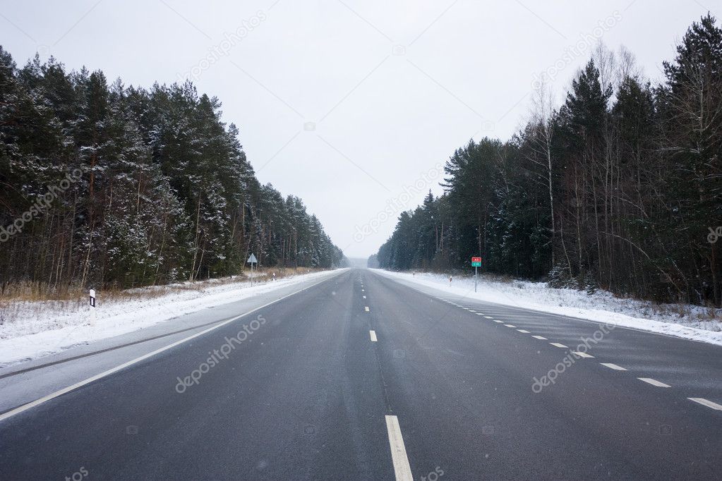 Winter road, the snow falls