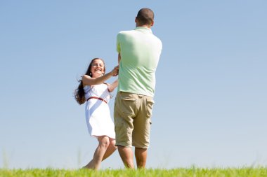 Young couple play at park