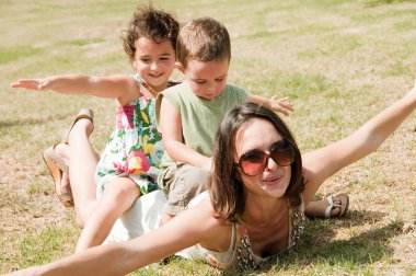 Kids sit and fly on mother's back clipart