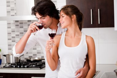 Happy young couple drinking wine clipart