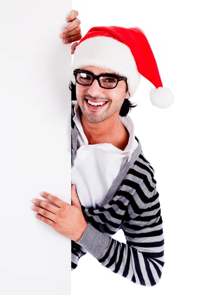 Weihnachtsmann zeigt auf leere Plakatwand — Stockfoto