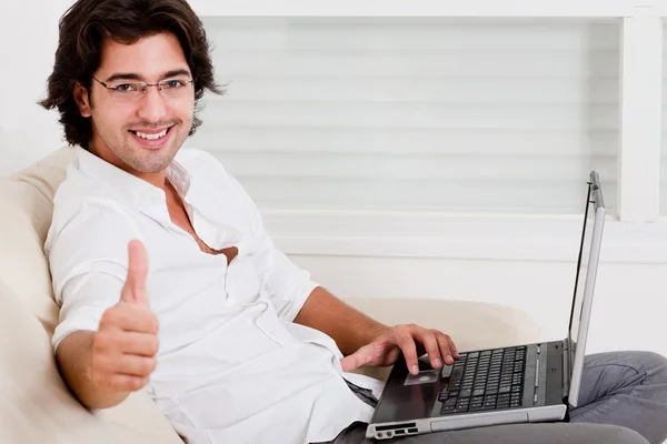 Homem usando laptop mostrando polegares para cima — Fotografia de Stock