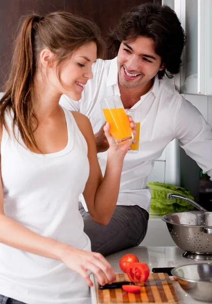 Couple in the kitchen with juice — Stock Photo, Image