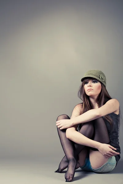 Girl sitting with her knees pulled up — Stock Photo, Image
