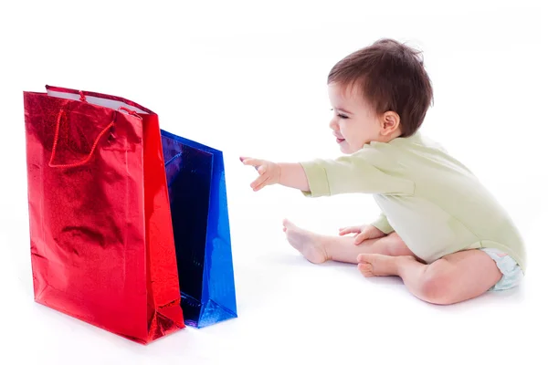 stock image Baby trying to pull shopping bag