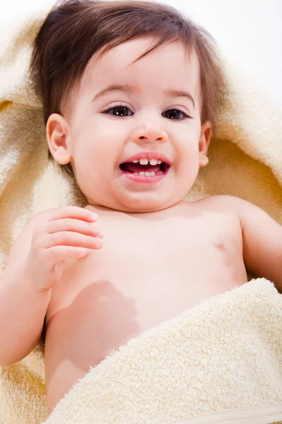 Happy baby wrapped in yellow towel — Stock Photo, Image