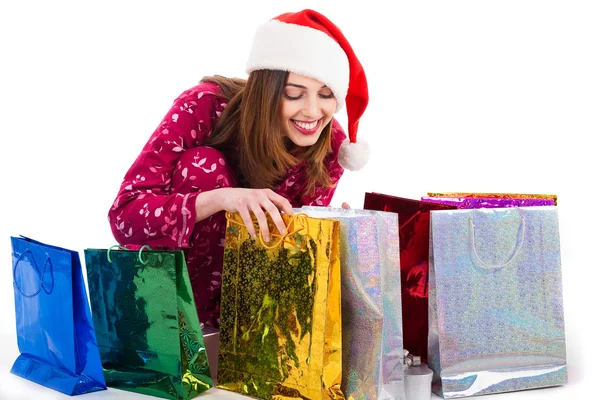 Santa meisje op zoek naar shopping tassen — Stockfoto