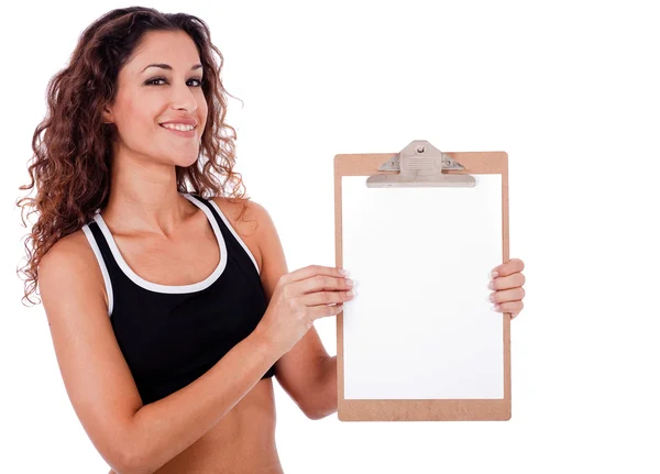 Mulher fitness mostrando uma placa de clipe em branco — Fotografia de Stock