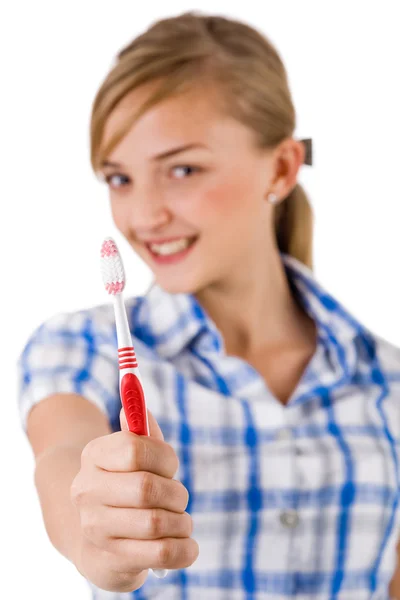 Young women showing the toothbrush — Stock Photo, Image
