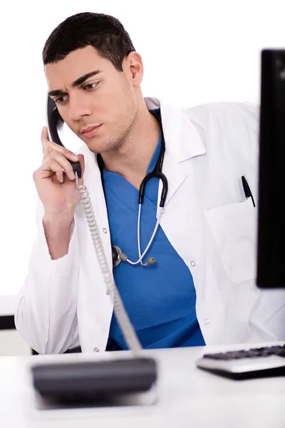 Мужчина-врач сидит за столом — стоковое фото