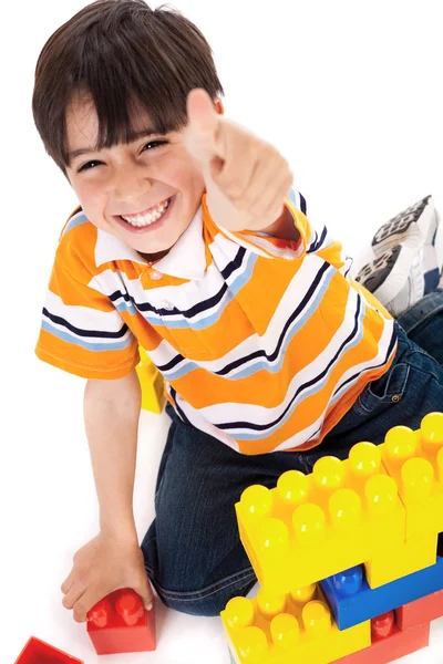 Boy shows ok sign when playing — Stockfoto