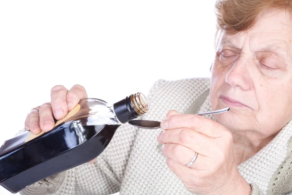 De oude vrouw giet een vloeistof — Stockfoto