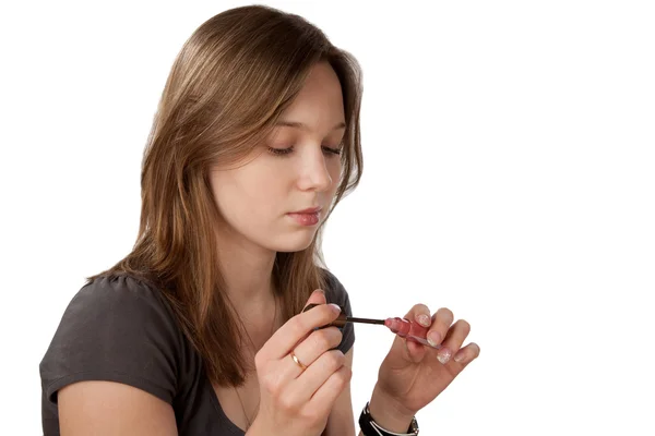 Mädchen mit Tube Lippenstift isoliert — Stockfoto