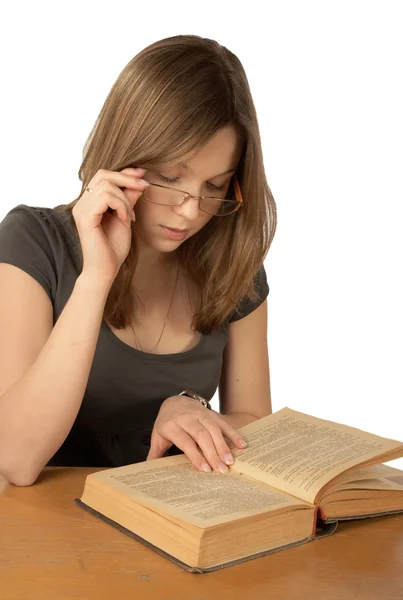 The girl in glasses reads the book — Stock Photo, Image