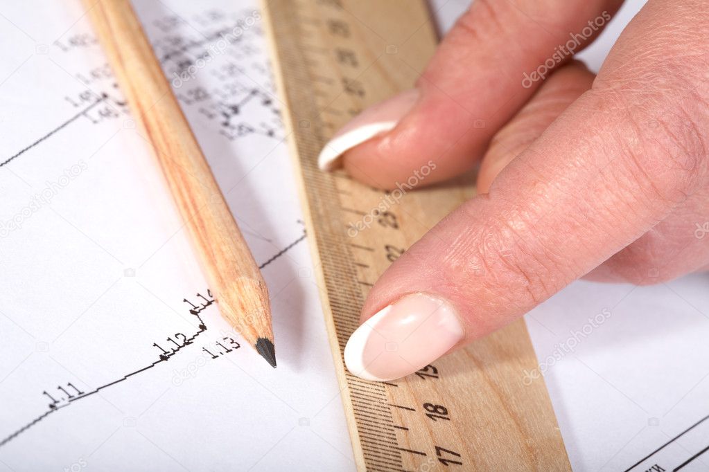 Female hands with a ruler and pencil