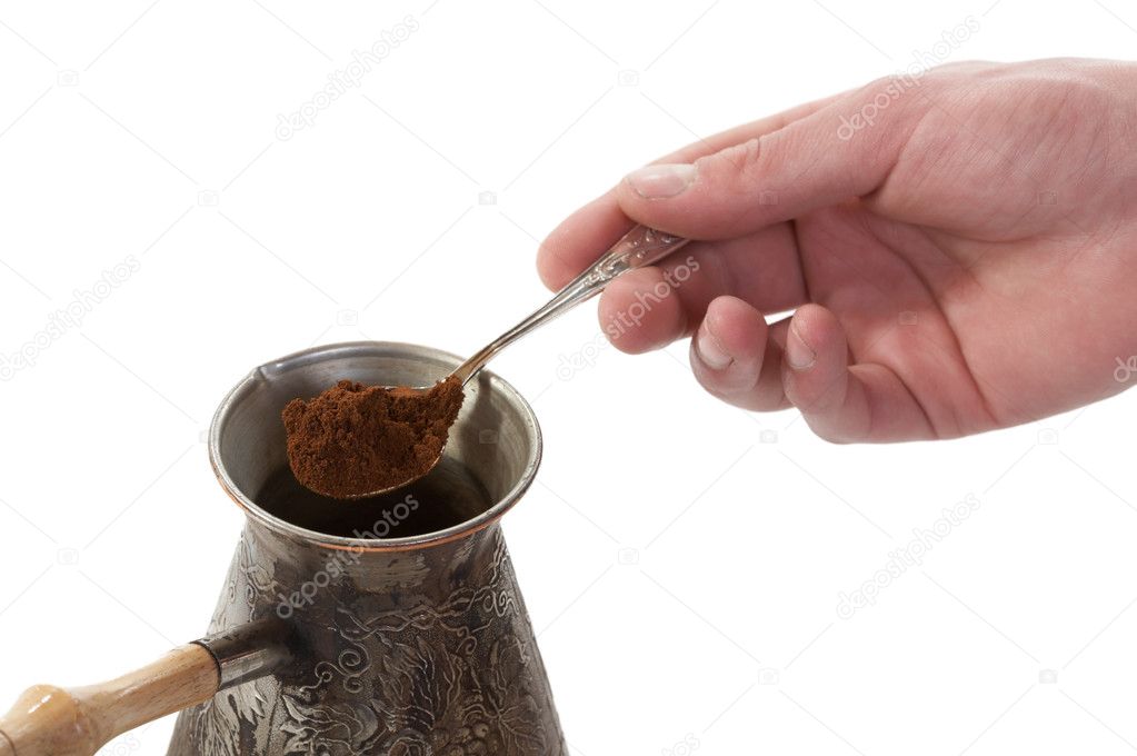 The spoon of ground coffee fallen in a c