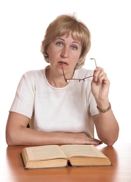 The mature woman with book behind — Stock Photo, Image