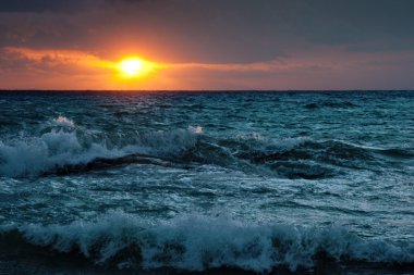 Stormy sunsrise on the sea clipart