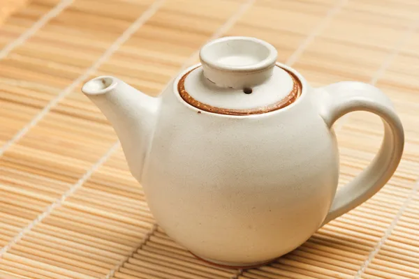 Chinese teapot on bamboo mat — Stock Photo, Image