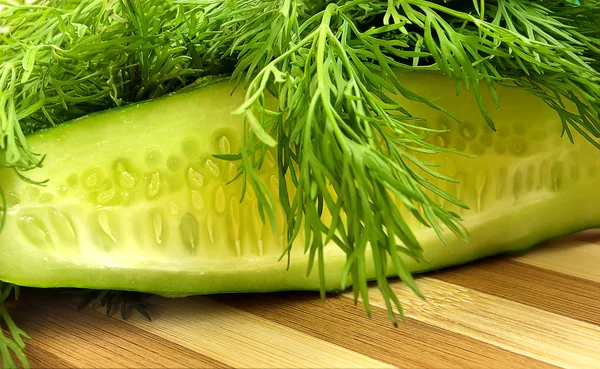 Dill and cucumber on the wooden desk — Stock Photo, Image