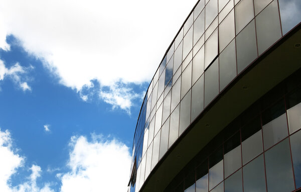 Office building on the blue sky background with clouds