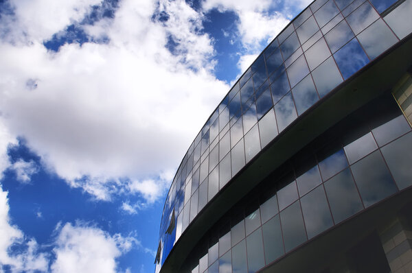 Office building on the blue sky background with clouds