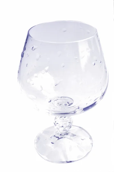 Glass cup with water droplets in the vio — Stock Photo, Image