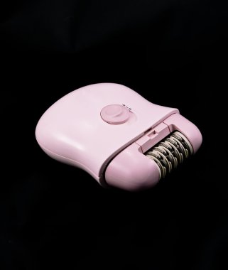 Pink depilator, isolated on the black clipart