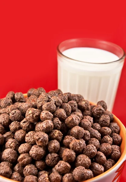 stock image Glass with milk and chokolate balls