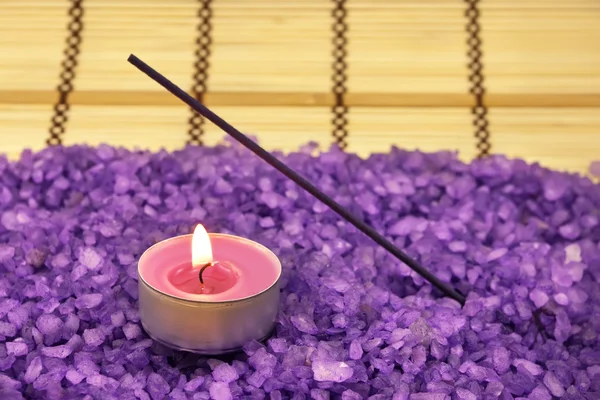 Pico de sal de banho violeta com vela — Fotografia de Stock
