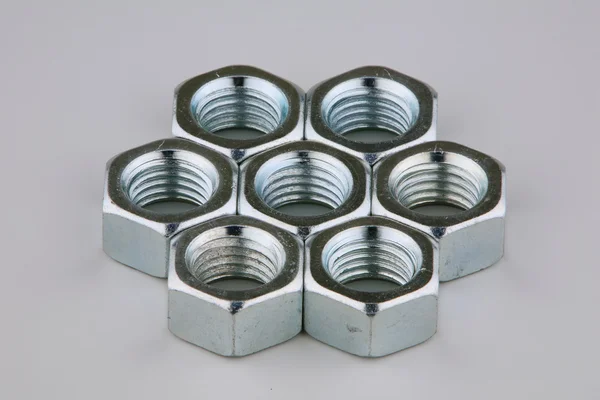 Seven metal nuts — Stock Photo, Image