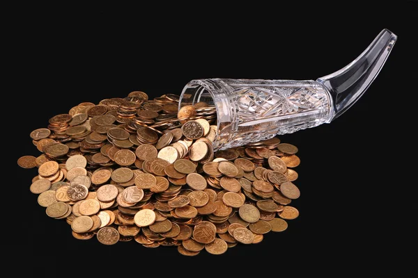 Crystal glass and small coins — Stock Photo, Image