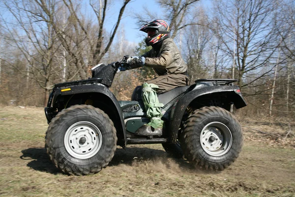 The man goes on ATV in the spring — Stock Photo, Image