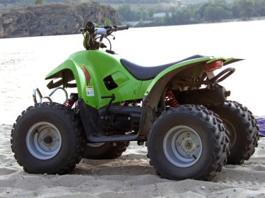 Small All Terrain Vehicle on coast of th clipart