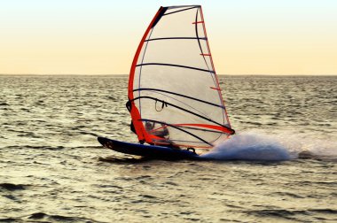 Silhouette of a windsurfer on a gulf, mo clipart