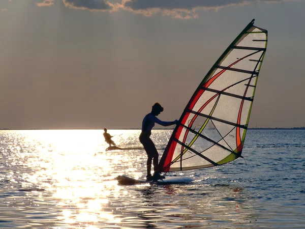 Een vrouw is leren windsurfen op de s — Stockfoto