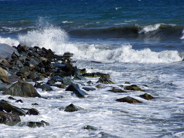 Wet stones in waves of the Black Sea