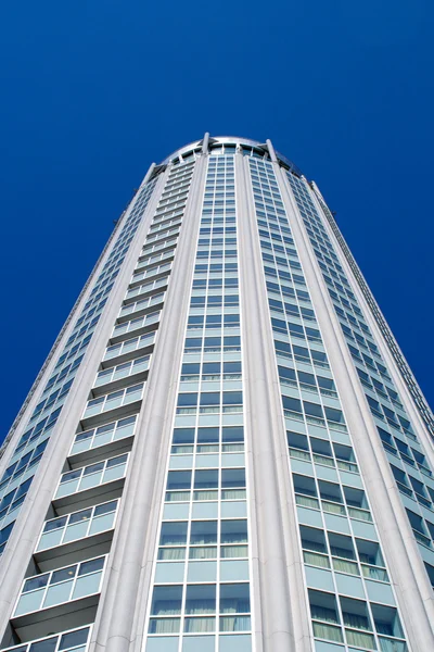 stock image High modern building on background blue