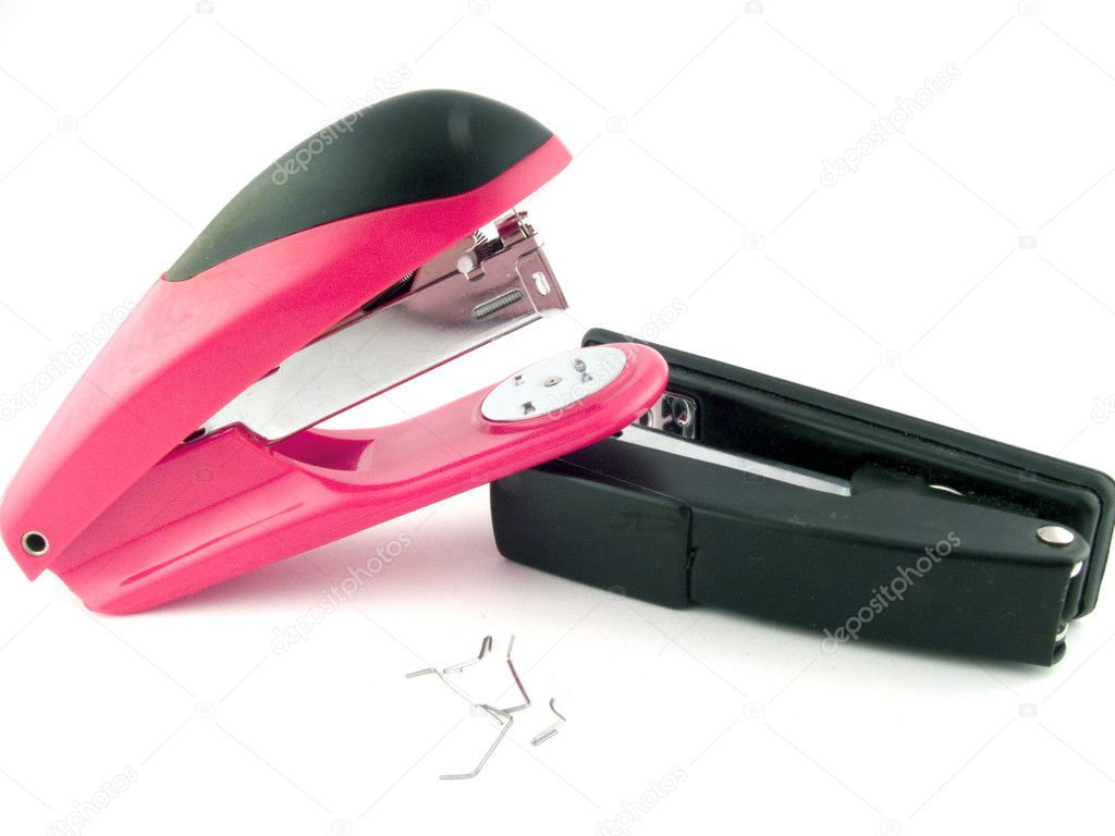 Red and black staplers on a white backgr