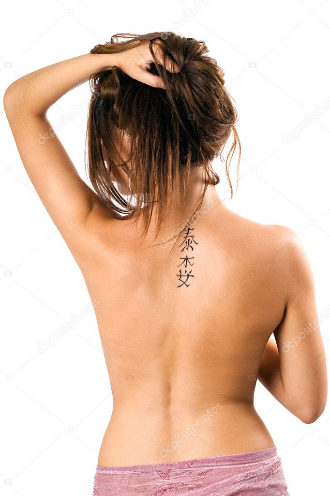 Tattoo on a back of the young woman. Iso