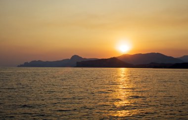 günbatımı üzerinde deniz ve dağlar. ukrai