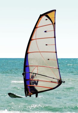 Silhouette of a windsurfer on the sea clipart