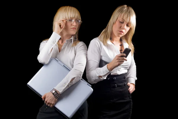 两个年轻的女企业家与便携式计算机和 — 图库照片