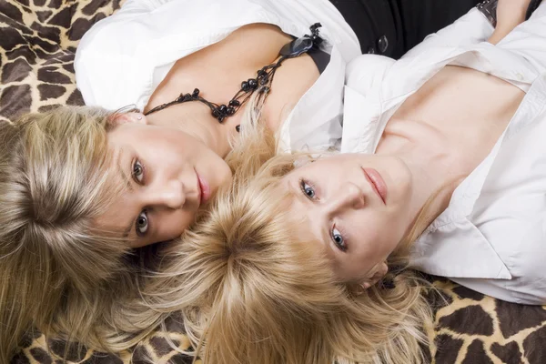 Two young beauty blonde lies on a bed — Φωτογραφία Αρχείου