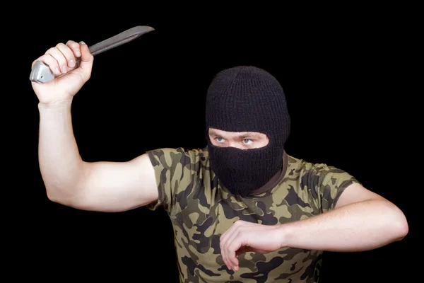 Вбивця з ножем у чорній масці — стокове фото