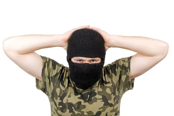 The surrendered terrorist in a black mas — Stock Photo, Image