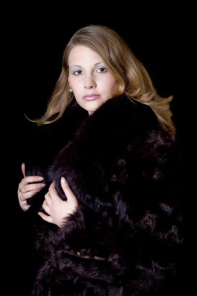 The young beautiful woman in a fur coat — Stock Photo, Image